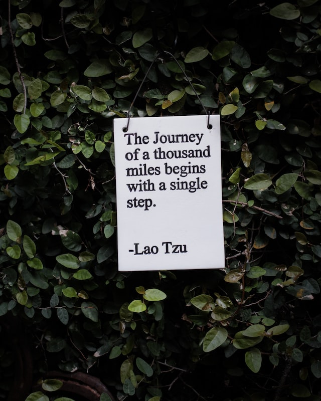 Sign that says, "The journey of a thousand miles begins with a single step," by Lao Tzu